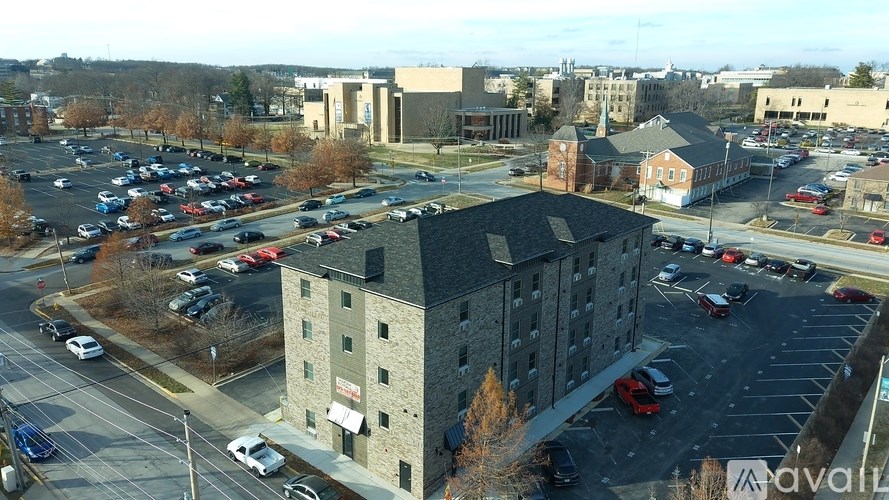 A parking lot with cars and a building in the background.