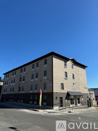 A building with a sign that says "avail" in front of it.