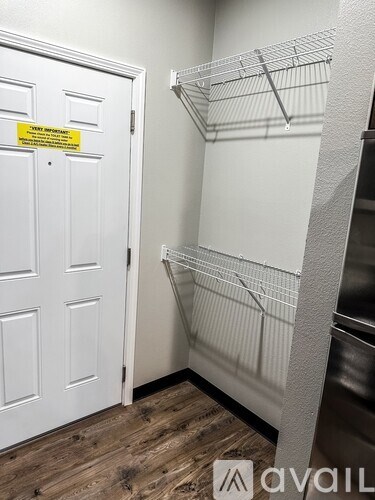 A white door with a yellow sign on it.