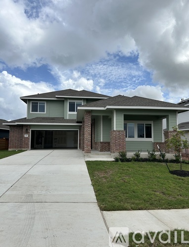 A house with a grey roof and a grey garage door.