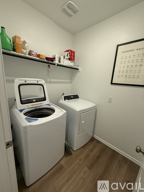 A small laundry room with a washer and dryer.