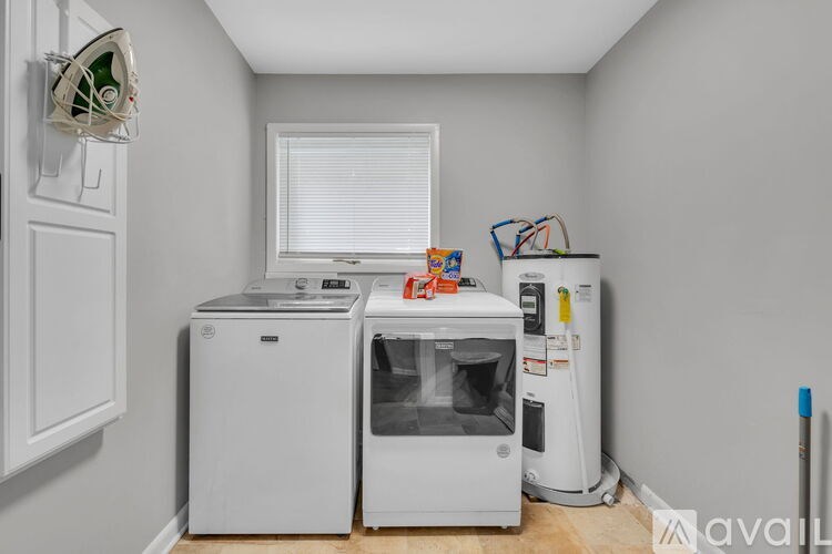 A small laundry room with a washer and dryer.