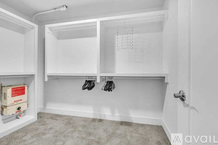 A white closet with a pair of shoes hanging on the rack.