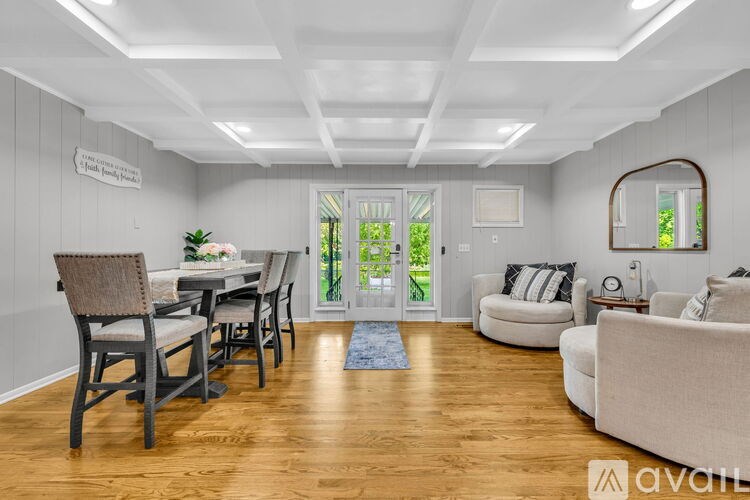 A living room with a dining table and chairs.
