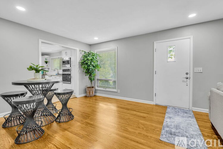 A living room with a dining table and chairs.