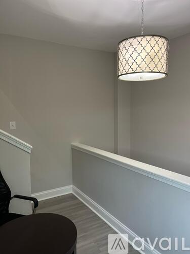 A room with a table and a lamp.