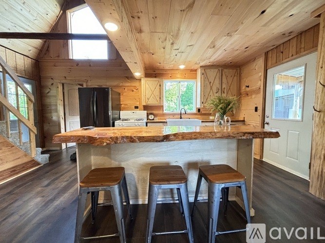 A kitchen with a bar stool and a counter.