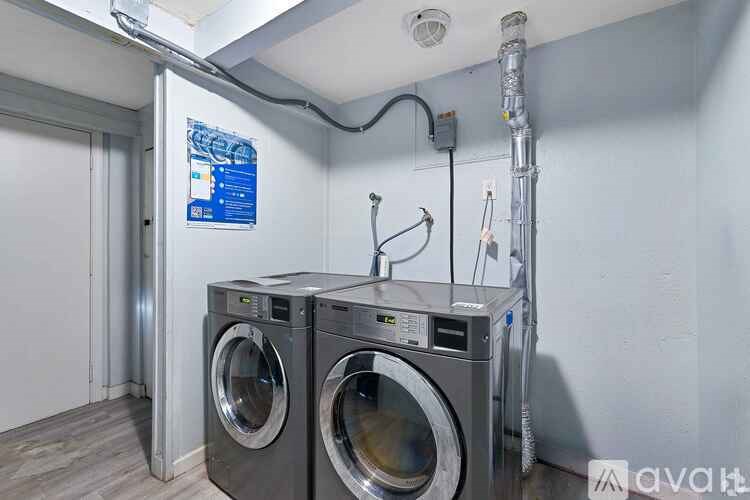 Two front load washing machines in a laundry room.