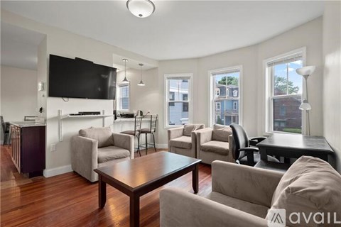 A living room with a television, couches, and a coffee table.