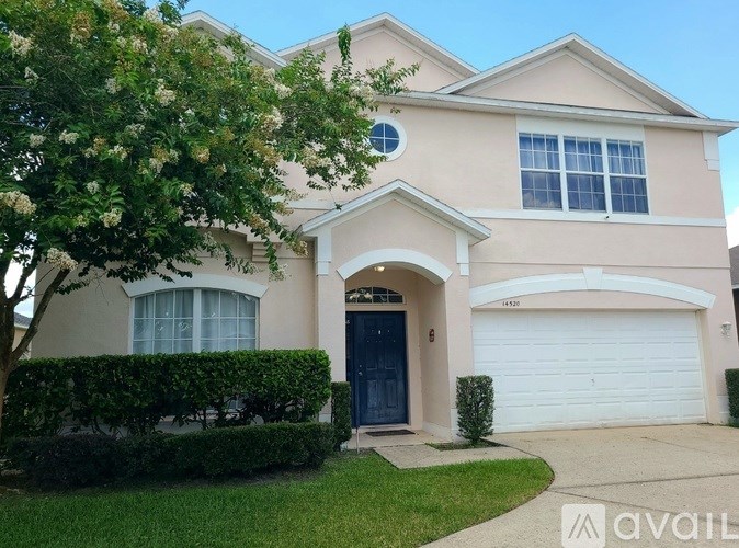 A house with a blue door and a white garage door.