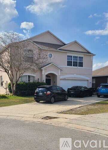 A house with a car parked in front of it.
