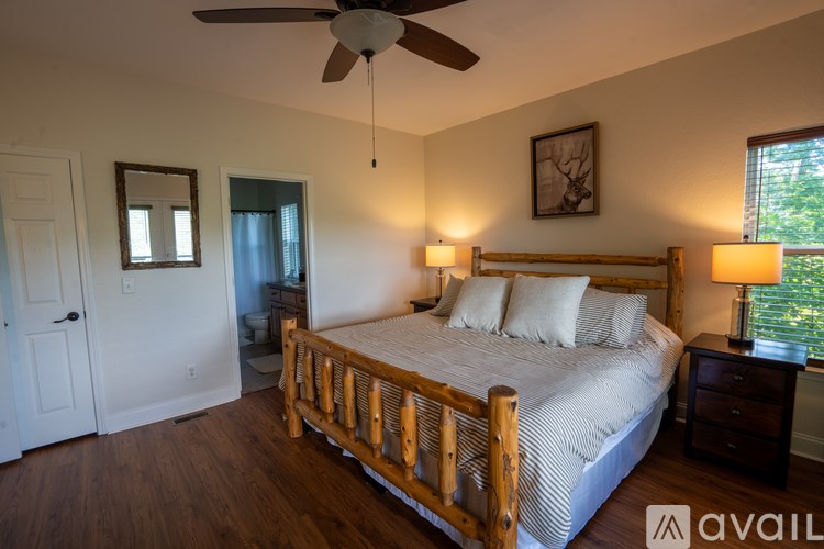 A bedroom with a bed, dresser, and window.