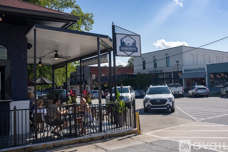 A sunny day at a restaurant with people dining outside.
