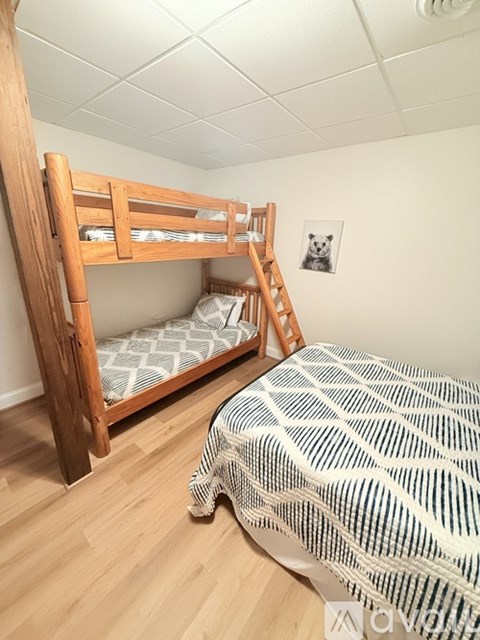 A bedroom with a bunk bed and a single bed.