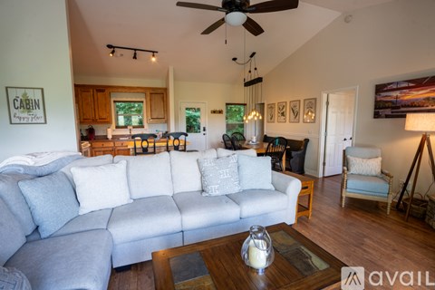 A living room with a grey couch and a wooden coffee table.