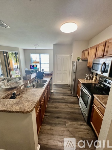 A kitchen with wooden cabinets and a granite countertop.