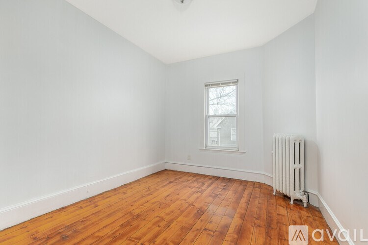 A room with wooden floors and a window.