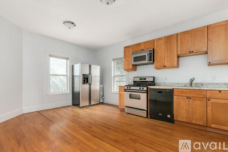 A kitchen with wooden cabinets and stainless steel appliances.
