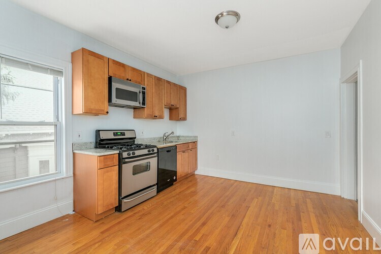 A kitchen with wooden cabinets and appliances is available for rent.