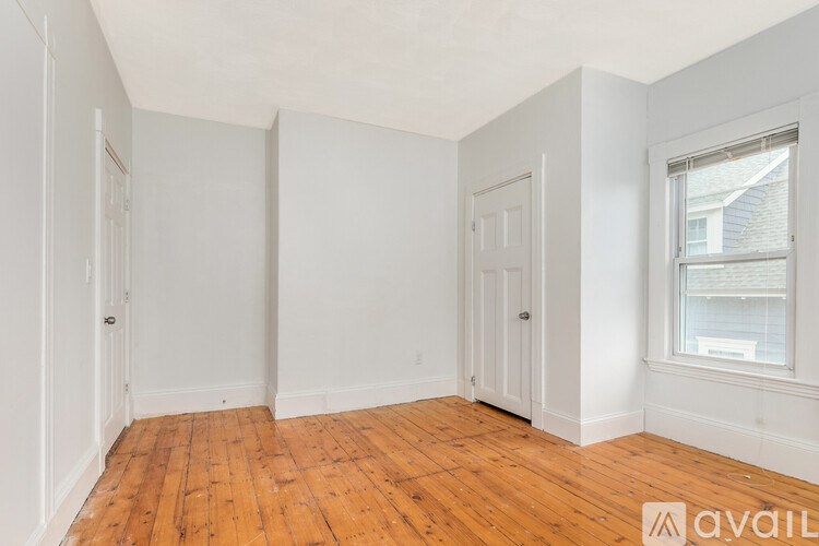 A room with wooden floors and white walls.