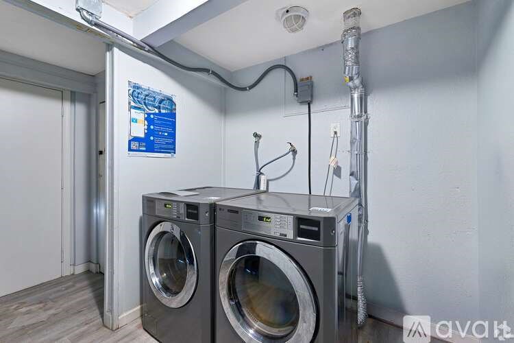 Two front load washing machines in a laundry room.