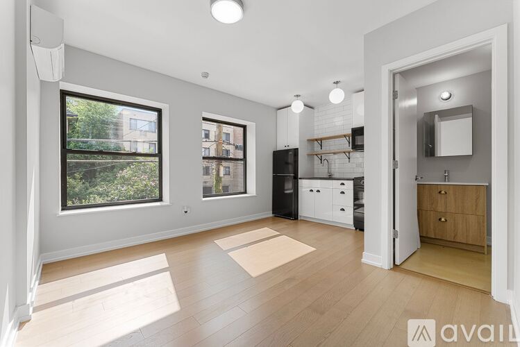 A spacious kitchen with a refrigerator, cabinets, and a countertop is visible.