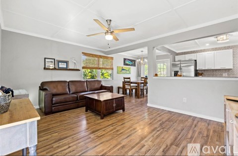A living room with a brown leather couch and a wooden coffee table.