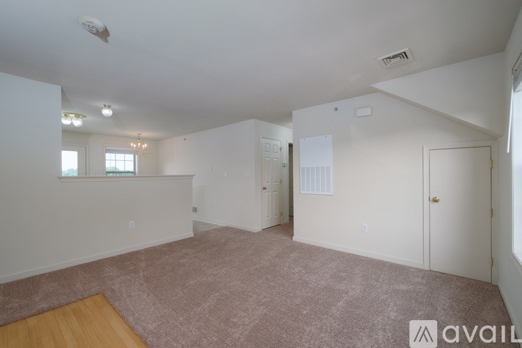 A gym with treadmills, elliptical machines, and a weight machine.