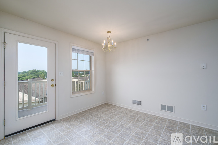 A room with a window and a door leading outside.