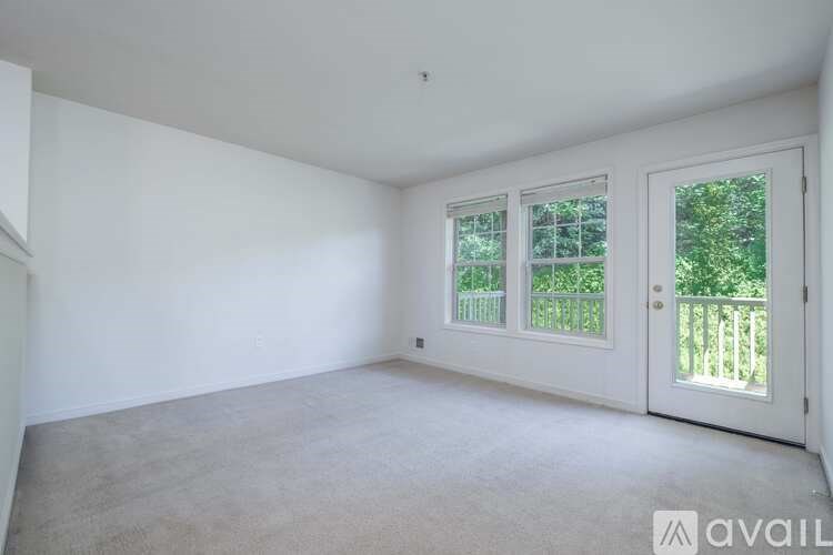 A room with a window and a door leading outside.