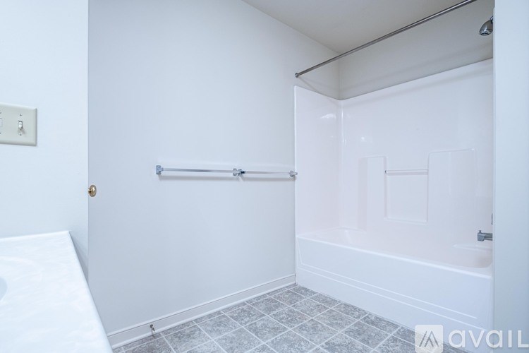 A bathroom with a toilet, sink, and mirror.