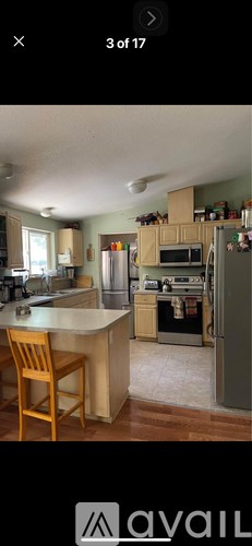 A kitchen with wooden floors and a white countertop.