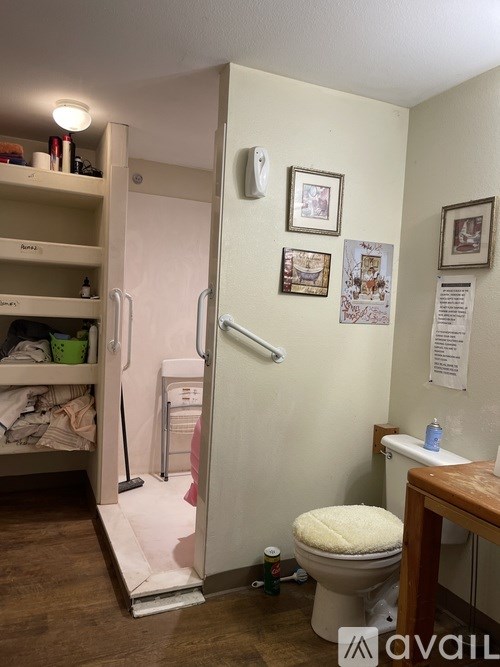 A small bathroom with a toilet, sink, and a walk-in shower.