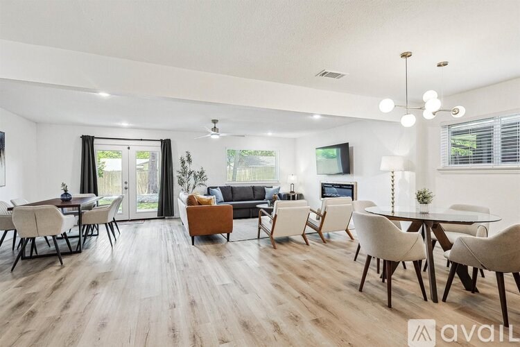 A modern living room with a dining area and a television.