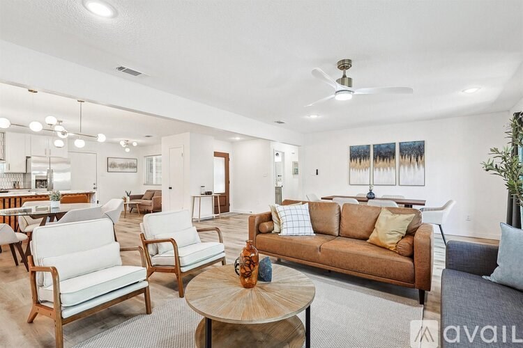 A living room with a brown couch and a wooden coffee table.