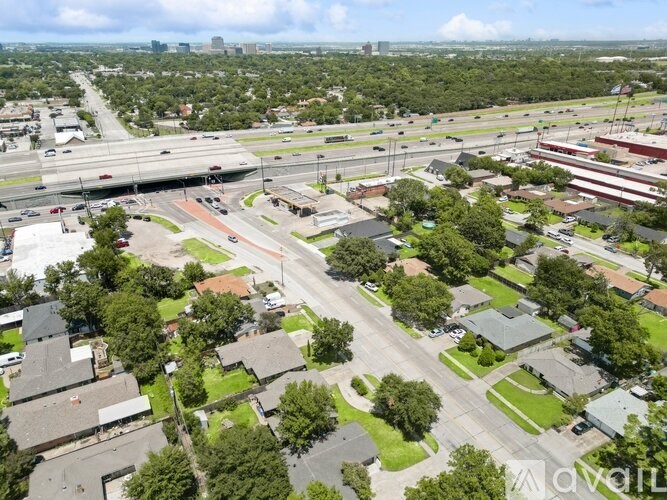 A bird's eye view of a city with a highway running through it.