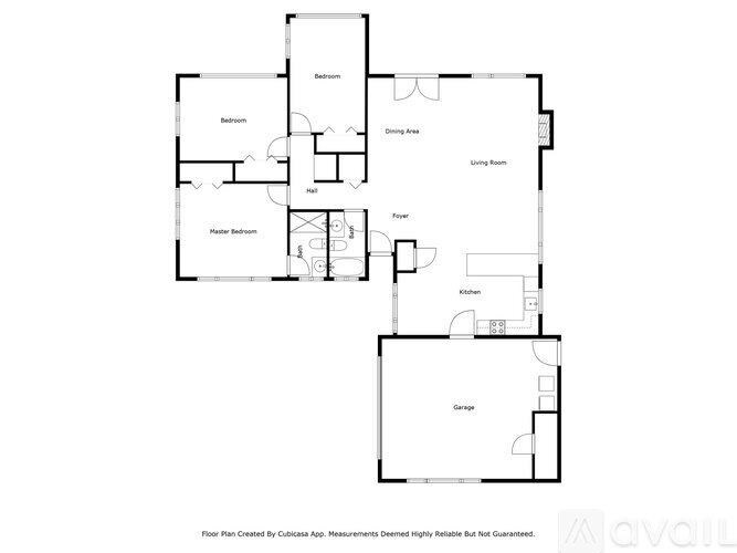 A floor plan of a house with a garage, living room, dining area, kitchen, and two bathrooms.