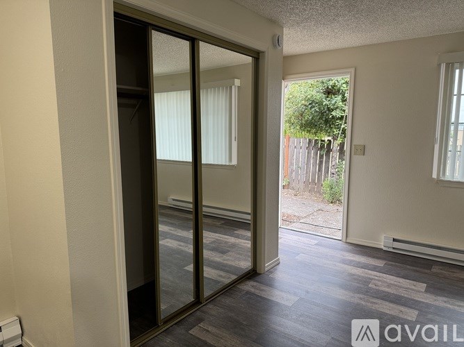 A room with a sliding glass door leading to a backyard.