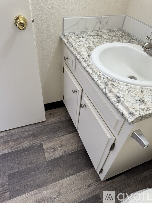 A bathroom with a sink and a white door.