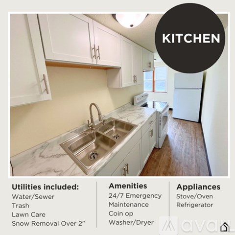 A kitchen with a sink, cabinets, and a refrigerator.