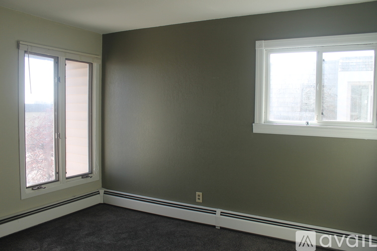 A room with a window on the right and a sliding glass door on the left.