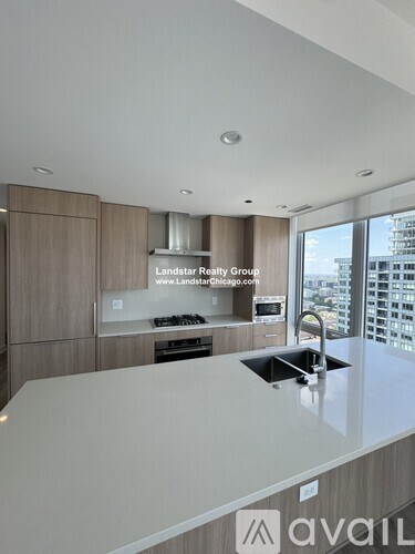 A modern kitchen with a large island and a sink.