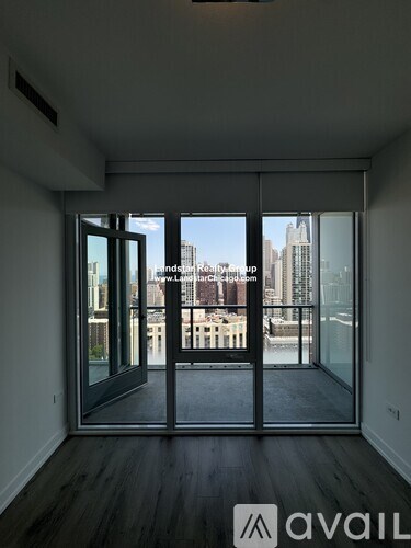 A room with a view of the cityscape through large windows.