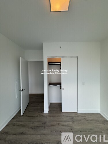 A room with a white door and a white wall with a logo on it.