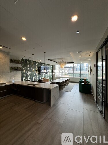 A modern kitchen with wooden floors and a large island.