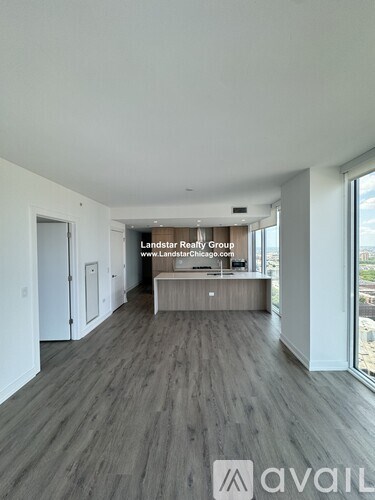 A spacious room with a reception desk and a view of the outdoors through the windows.
