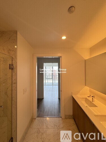 A bathroom with a marble floor and a mirror on the wall.