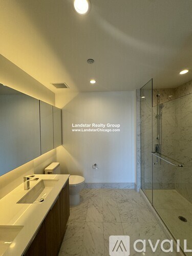 A bathroom with a sink, toilet, and shower area.