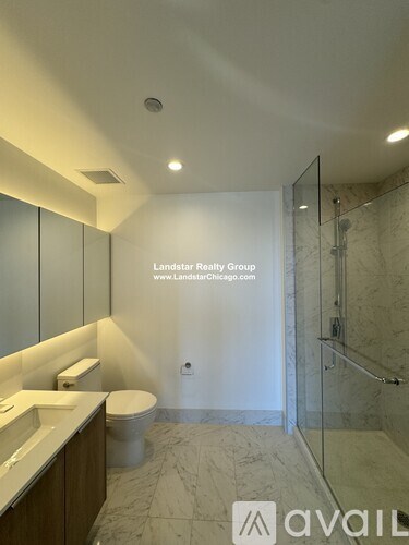 A bathroom with a toilet, sink, and shower.