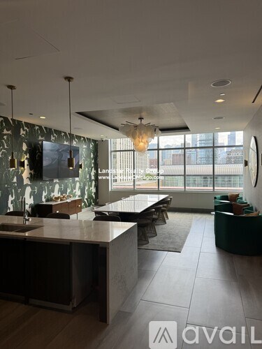 A modern kitchen with a marble backsplash and a large island.